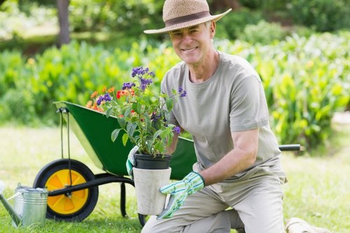 London gardener using advanced equipment for patio cleaning